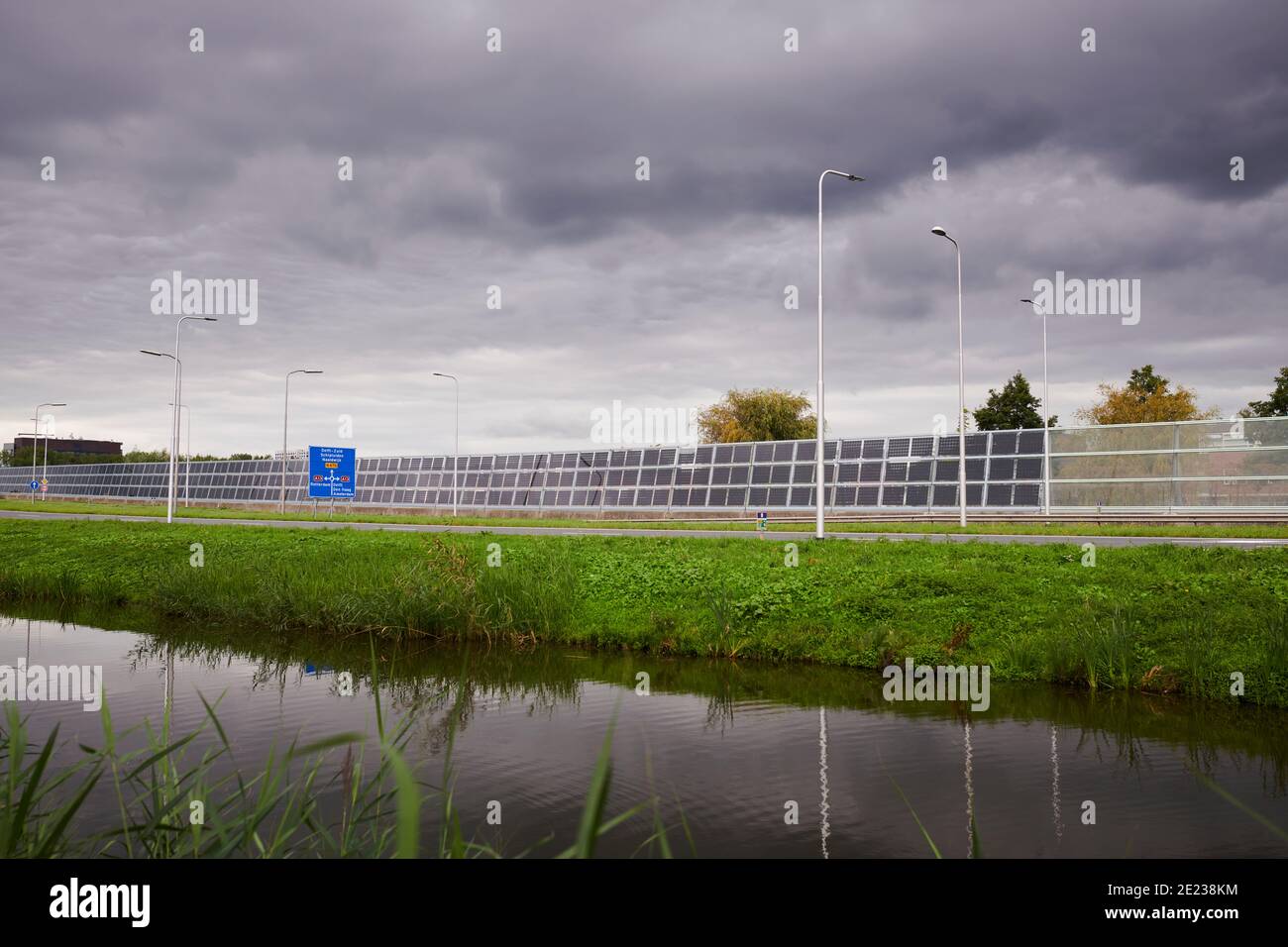 Solar panels on a noise barrier along a motorway Stock Photo Alamy