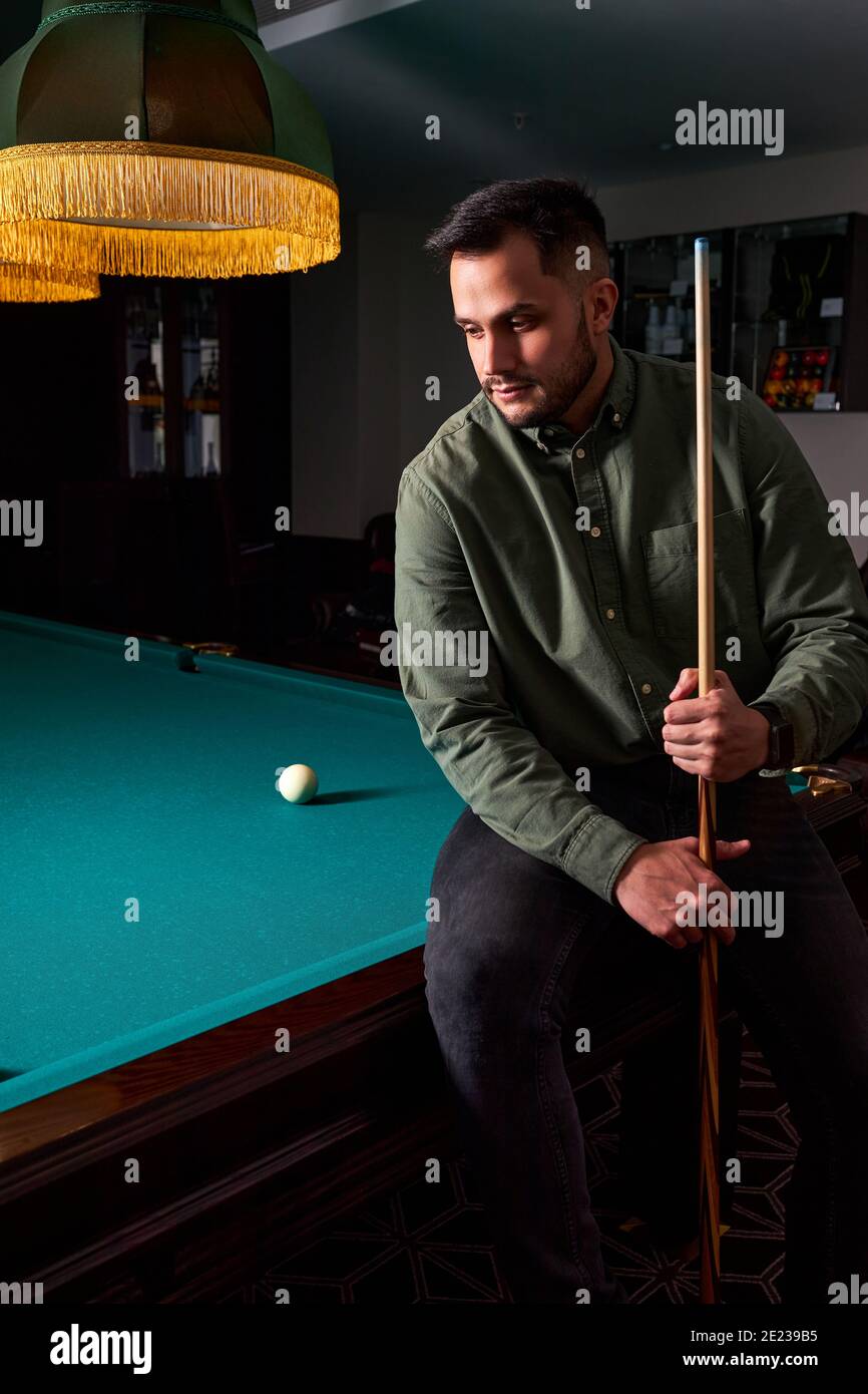 guy sits depressed after bad billiards game, loser had unsuccessful snooker game. portrait Stock Photo