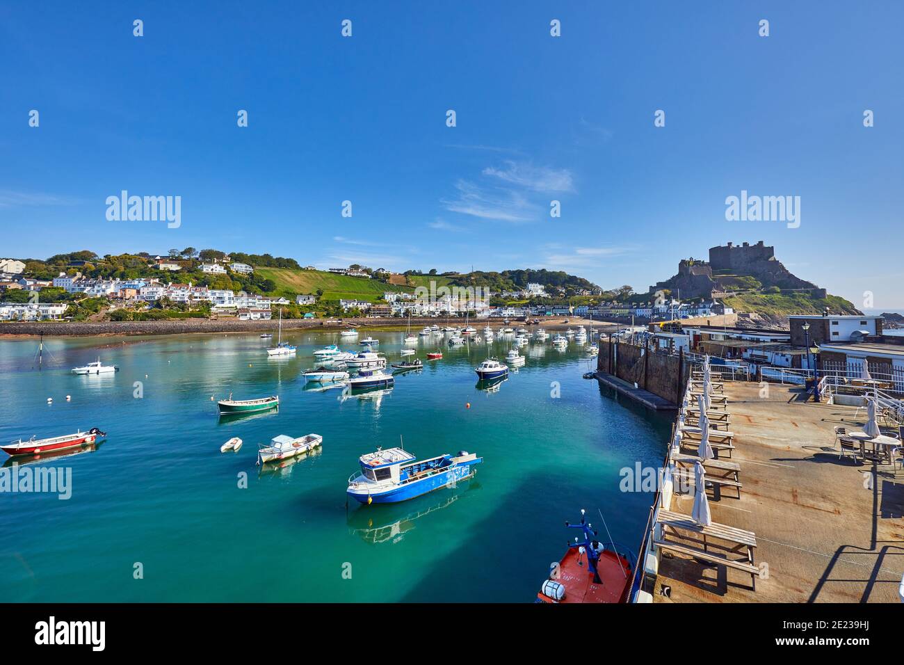 Image of Gorey Harbour with fishing and pleasure boats, the pier bullworks and Gorey Castle in
