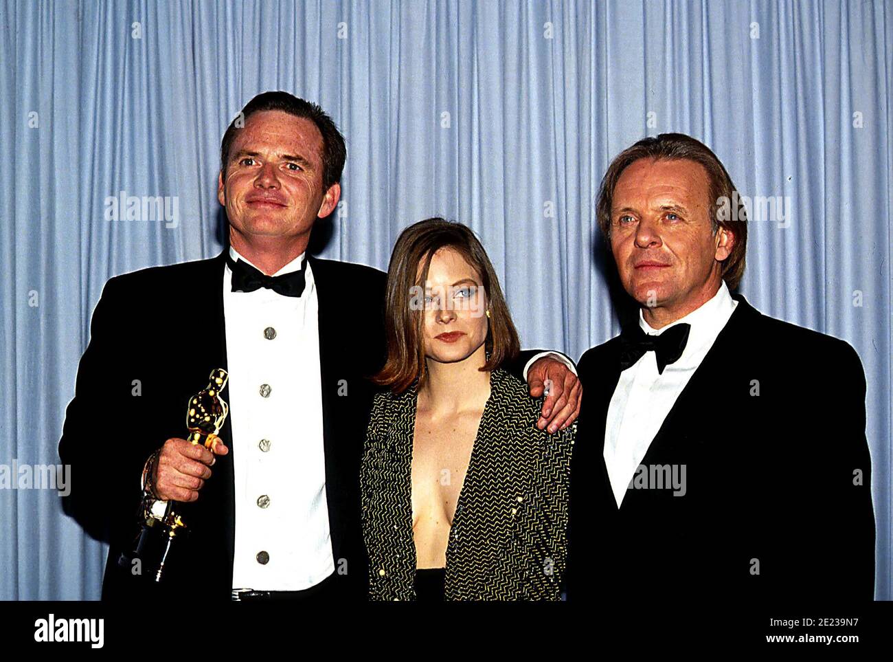 Michael Blake, winner Best Adapted Screenplay for 'Dances with Wolves,' with presenters Jodie Foster and Anthony Hopkins at the 63rd Annual Academy Awards on March 25, 1991.  Credit: Ralph Dominguez/MediaPunch Stock Photo
