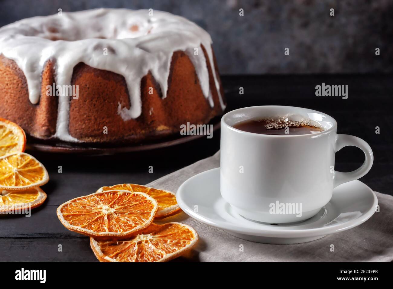 Cup of tea with oranges and a piece of homemade muffin Stock Photo