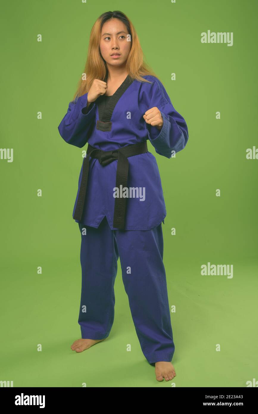 Young Asian woman wearing blue karate Gi against green background Stock Photo Alamy