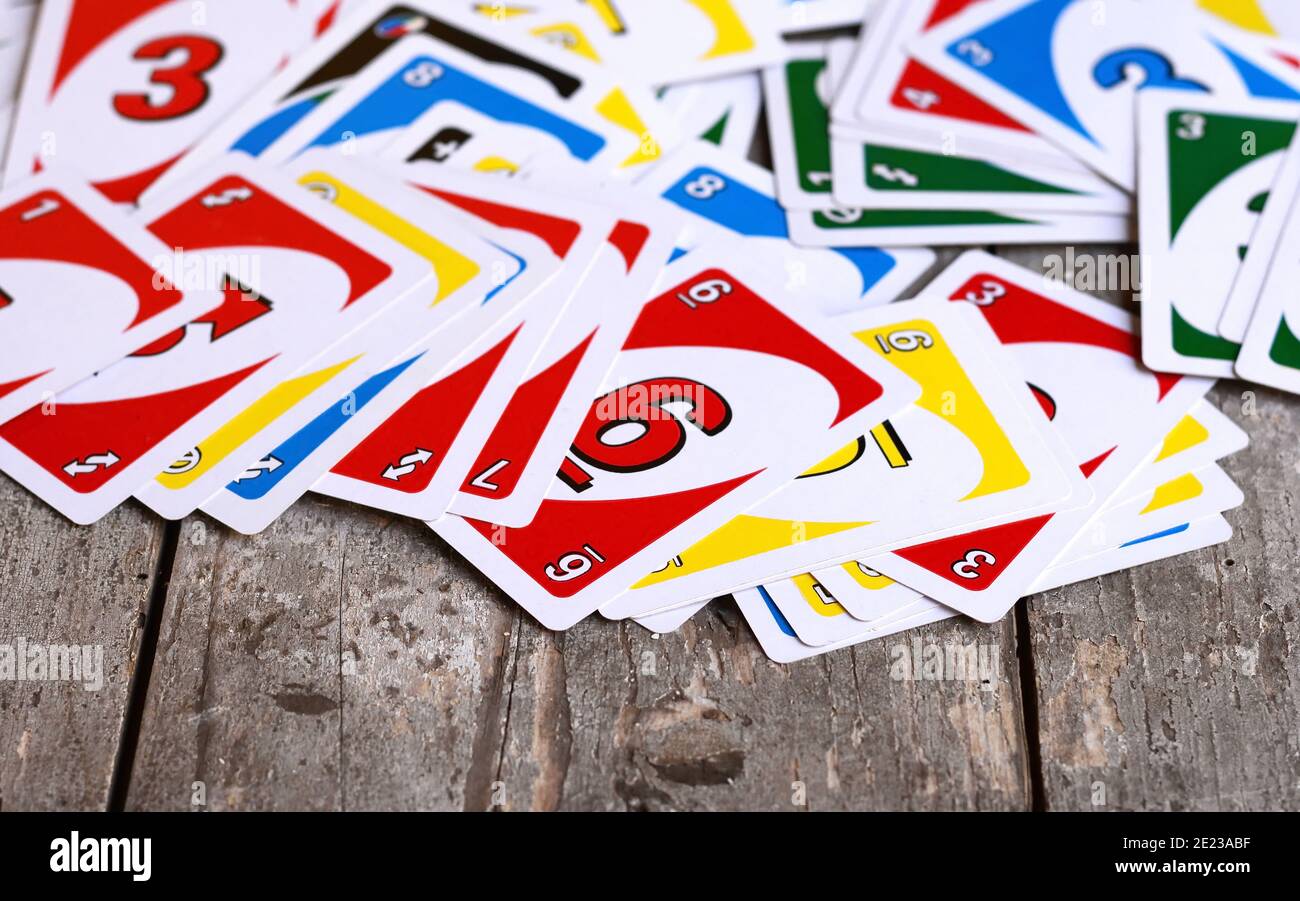 Deck of Uno Game Cards Scattered All Over on a Table. American