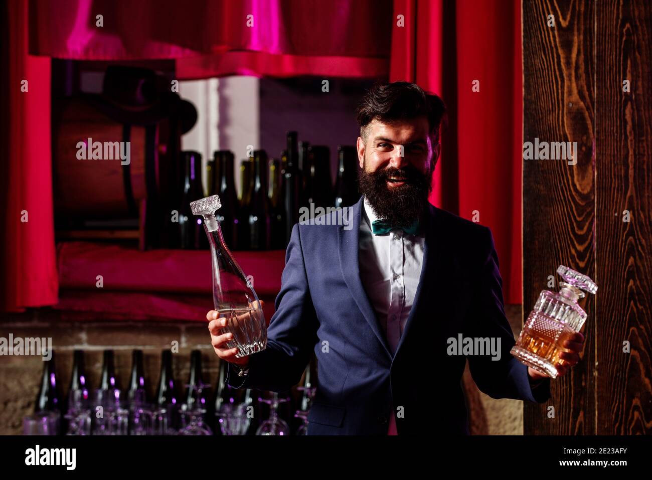 Bearded barmen, barkeeper or bartender in bar. Man with beard and mustache, vintage retro design Stock Photo