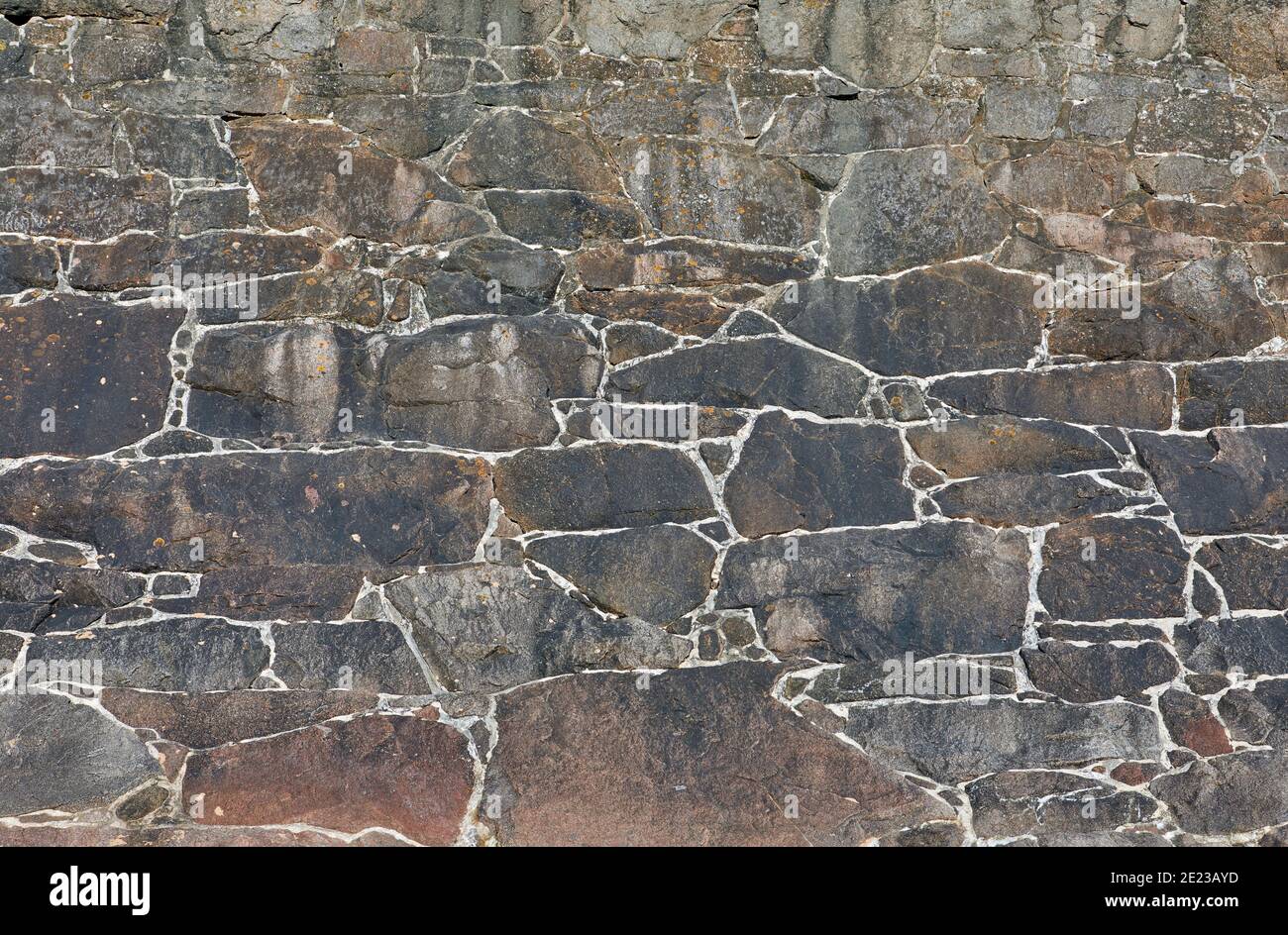 Image of a granite stone coastal wall. Textured background. Stock Photo