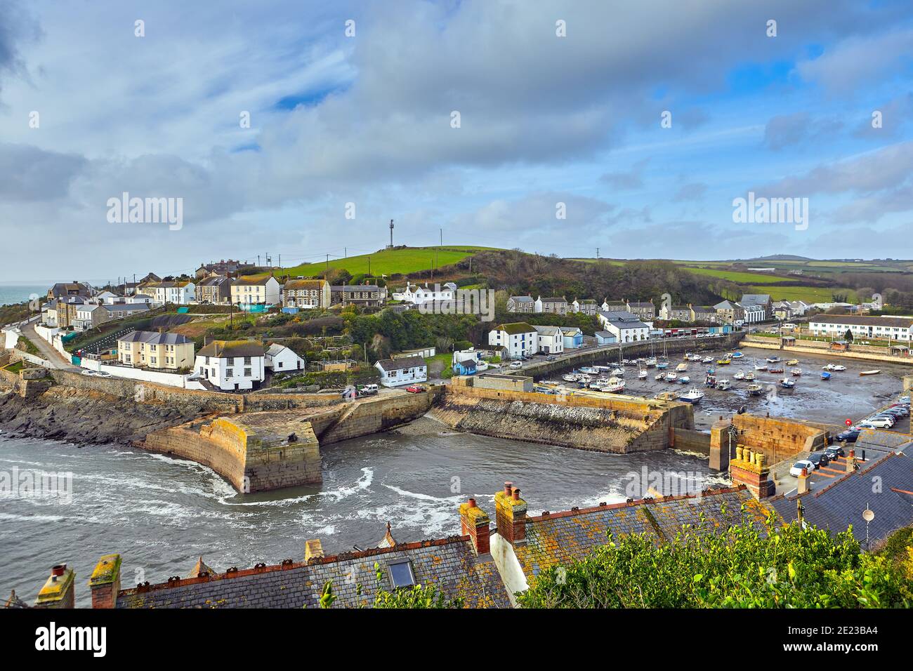 Image of Porthleven, Cornwall with a cloudy sky and the inner harbour dry. Stock Photo