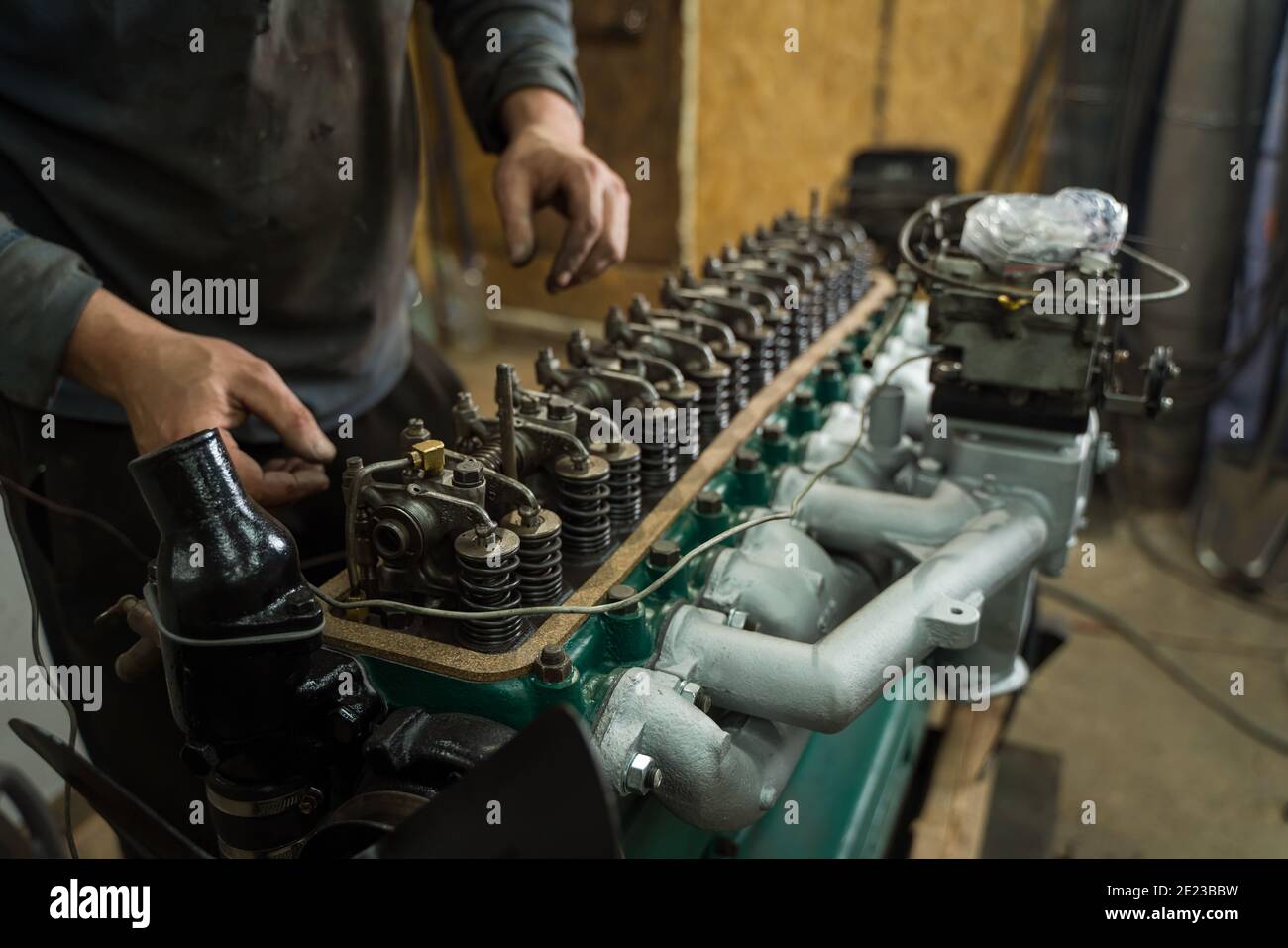 Car mechanic repairing an engine. Mechanic working on car engine