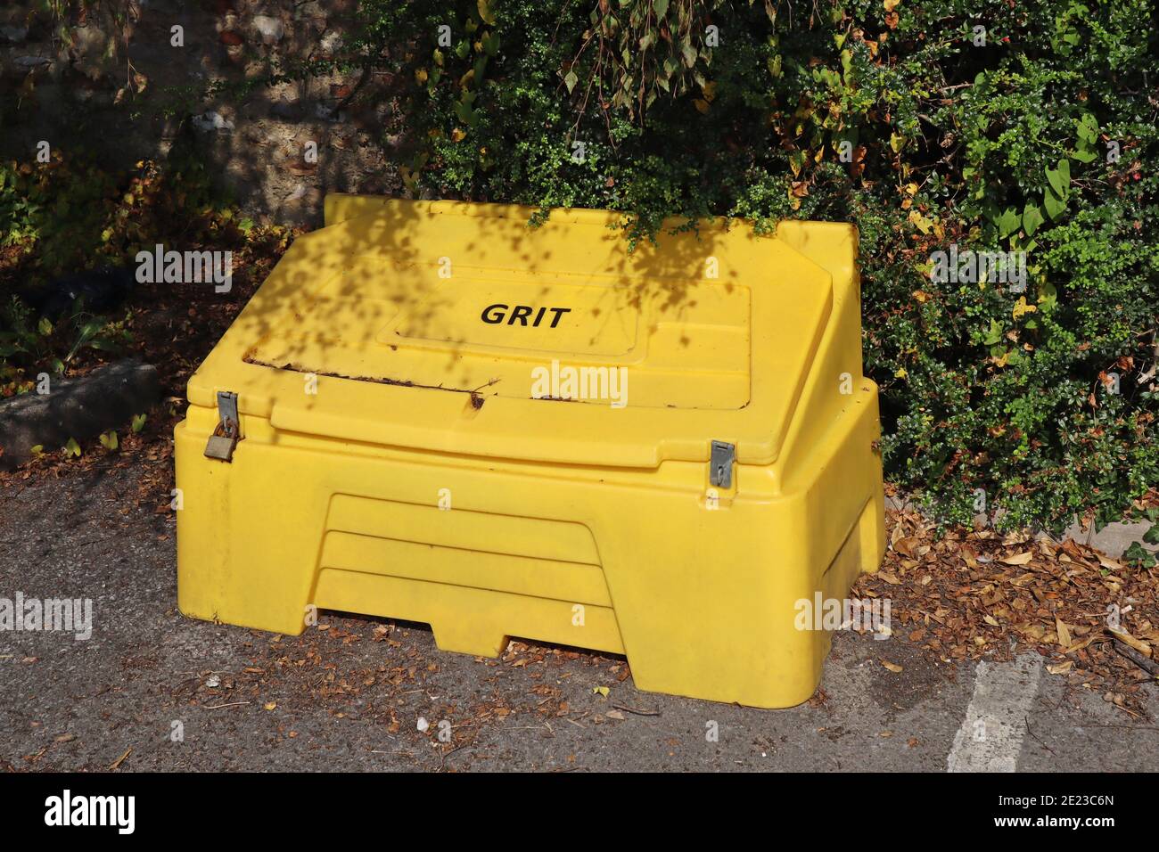 A yellow grit bin in a public car park in readiness for winter driving