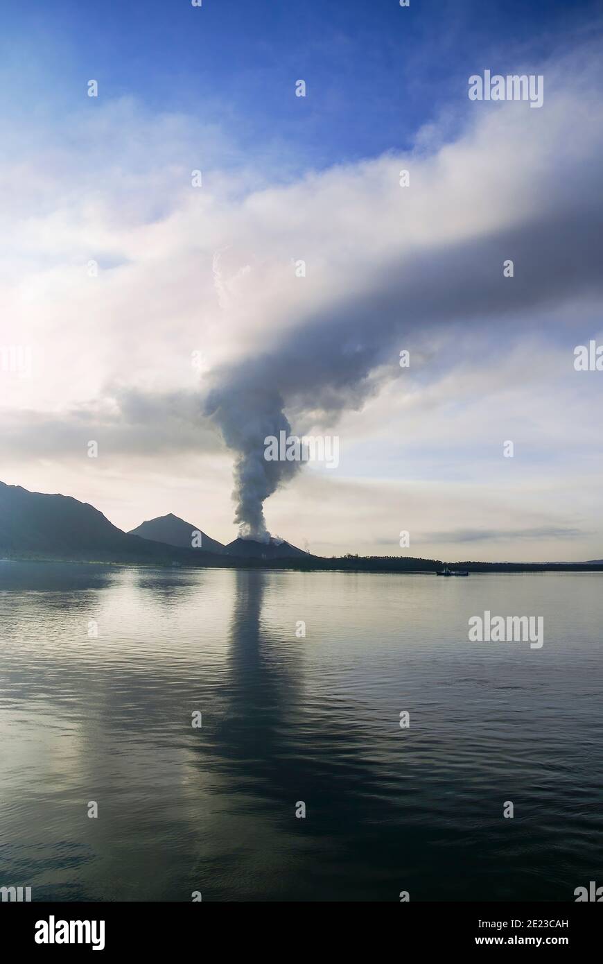 Tavuvur Volcano seen at sunrise from Simpson Harbour near   Rabaul, Papua New Guinea. Stock Photo