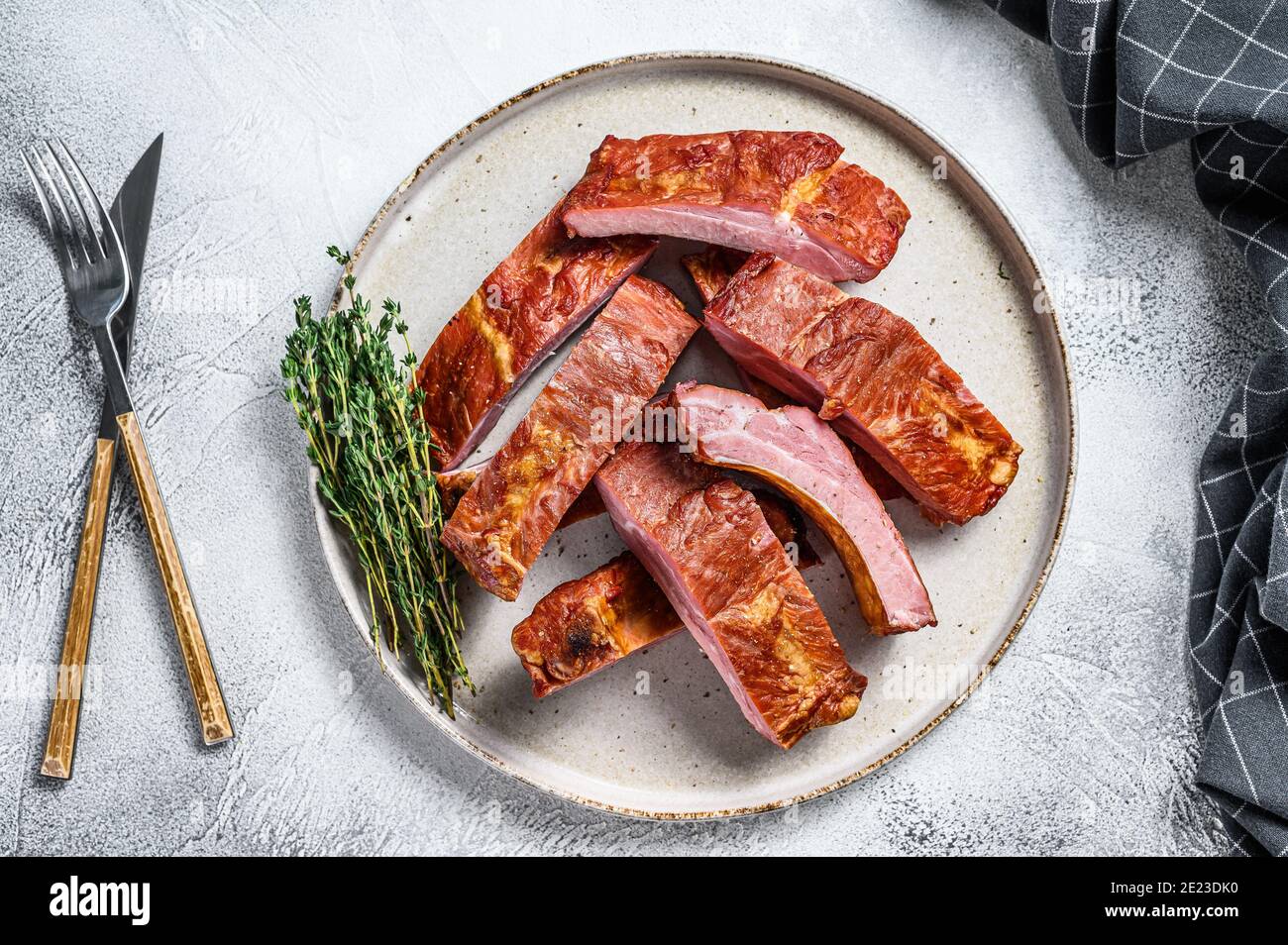 Sliced bbq pork ribs in a sauce. Gray background. Top view Stock Photo