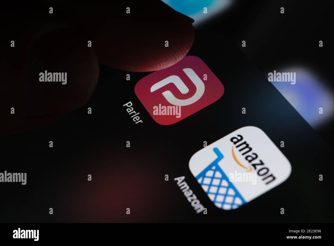 Parler app and Amazon app seen on the screen of iPad. Concept. Parler is a social media platform banned by Amazon AWS. Stock Photo