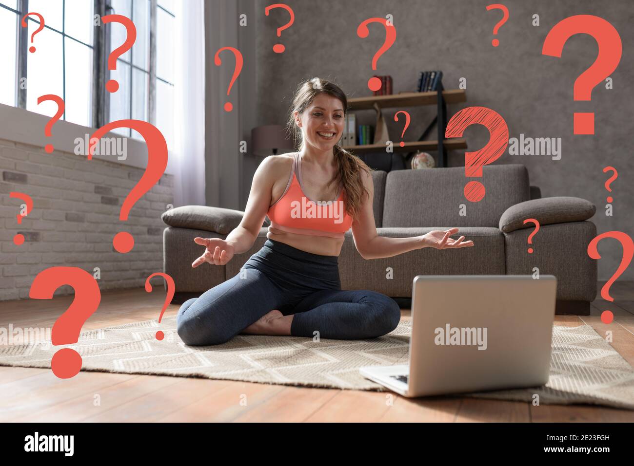 Young woman follows gym exercises with a laptop but sha has some