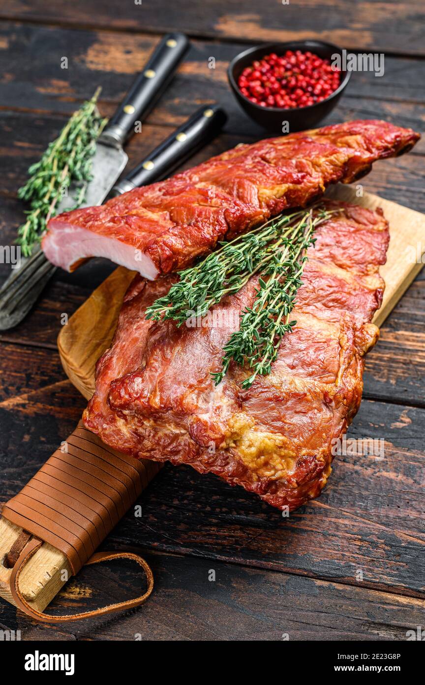 Barbecue pork ribs with spicy sauce. Dark wooden background. Top view Stock Photo