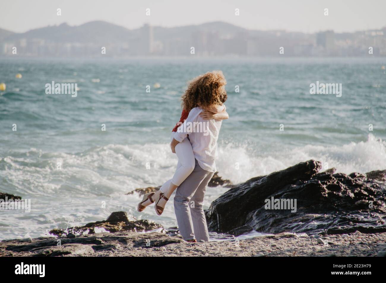 A boy holding a girl in his arms. Lovely couple Stock Photo Alamy