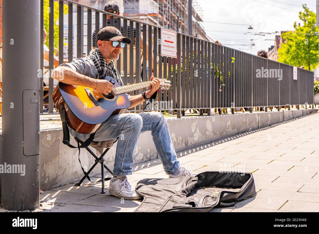 A cool man who is playing on the street for a bit of money to live. It was such a beautiful moment Stock Photo