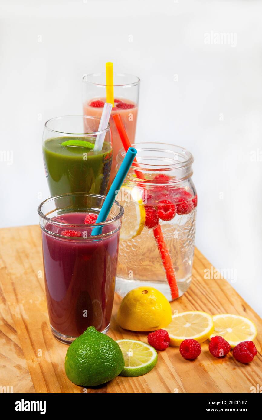 A serving platter with four drinks and smoothies lined up using food-grade, silicone straws that are reusable, and a plastic alternative to be sustain Stock Photo