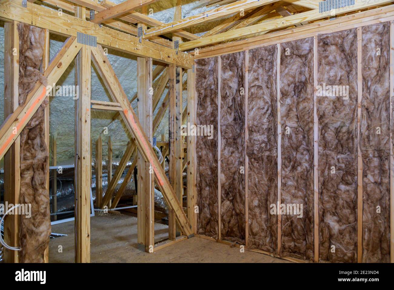 Fiberglass cold barrier insulation material in the sloping attic of a