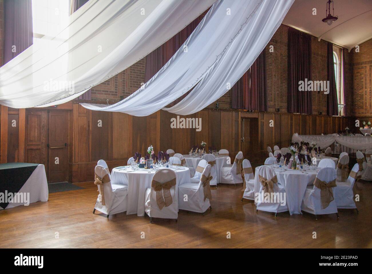 A bride has decorated the banquet room of the Newcastle Community Hall for her wedding with beautiful DIY decorations, ready to finally enjoy her big Stock Photo