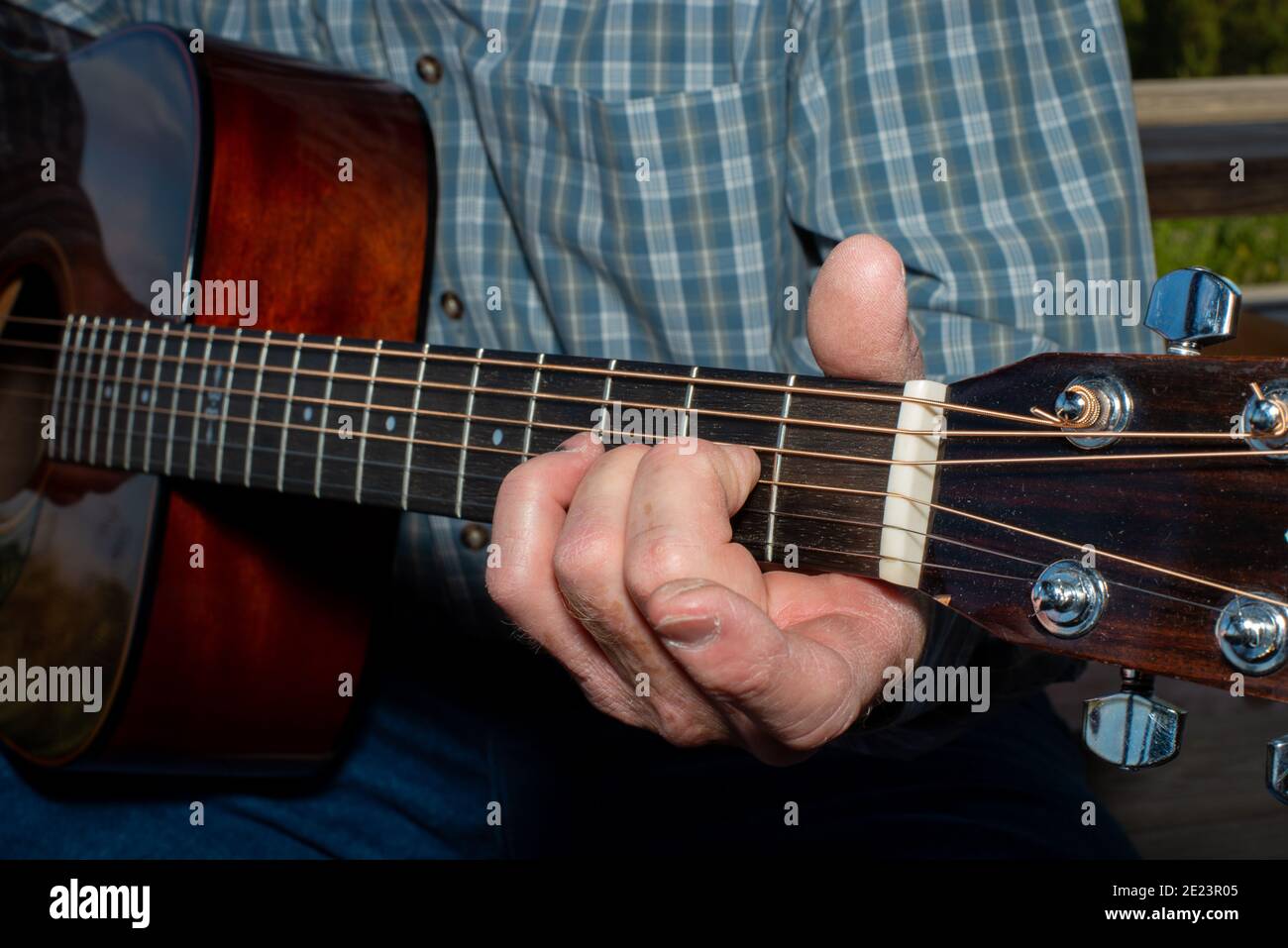 Senior man playing classical guitar outdoors Stock Photo