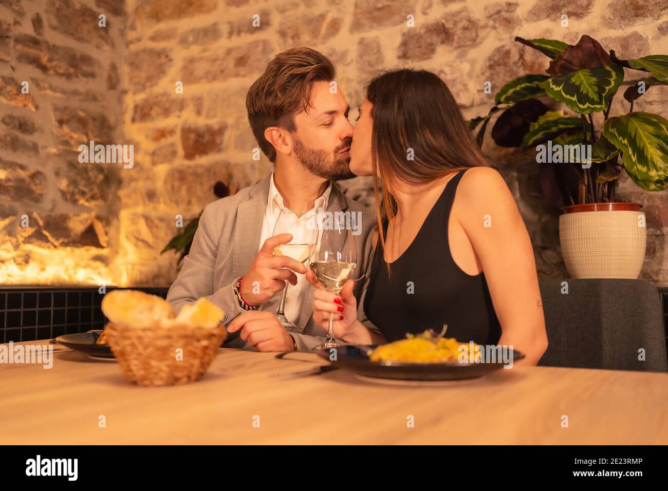 Loving couple kissing and enjoying dinner in a restaurant Stock Photo