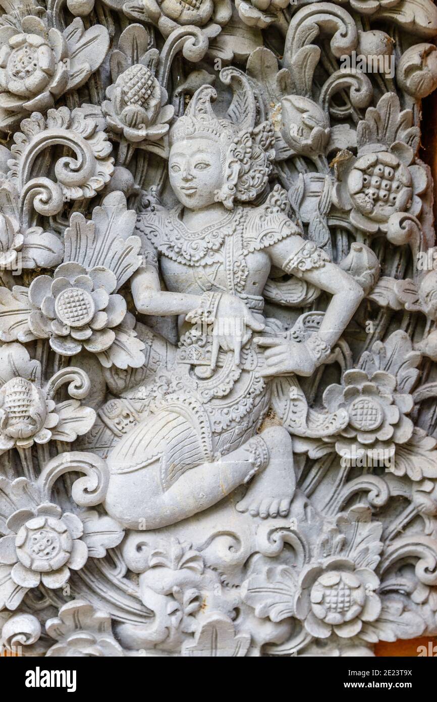 Traditional Balinese stone carving, Ubud, Gianyar, Bali, Indonesia. Vertical image. Stock Photo