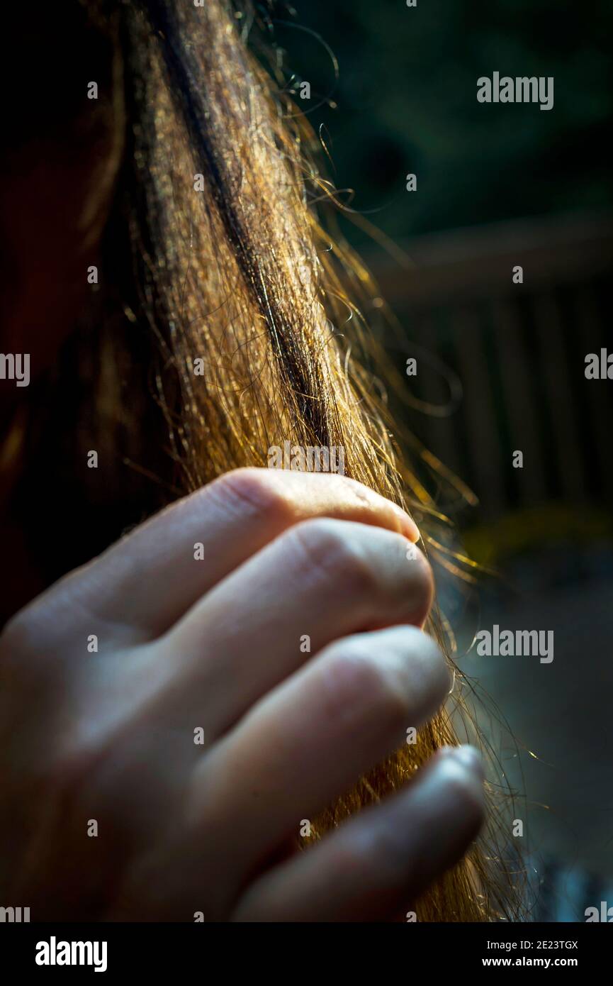 Woman brushing her hair with her fingers Stock Photo Alamy