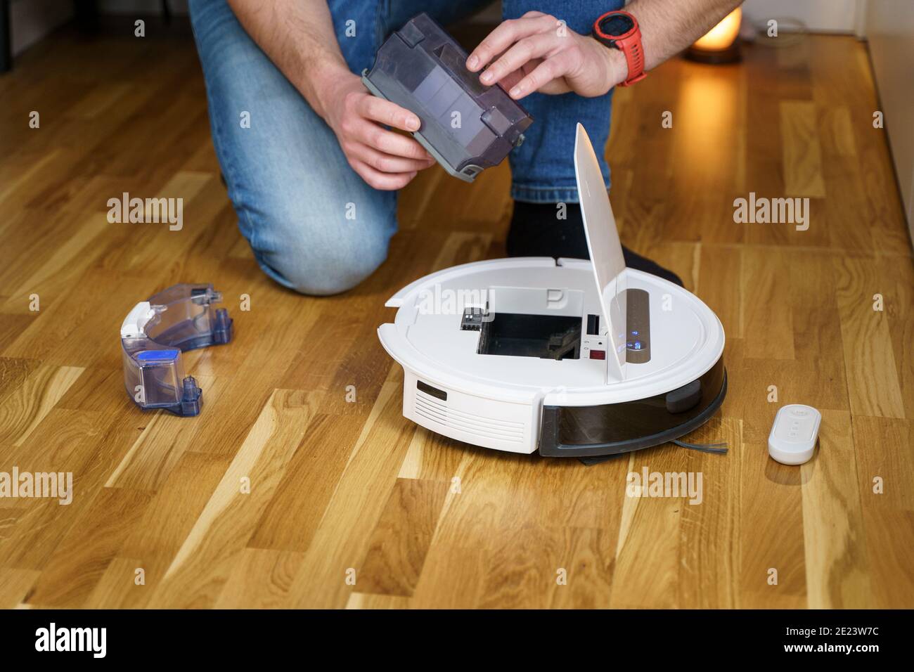 Robot vacuum cleaner repair. Man fixing robot vacuum cleaner DIY at home on  the floor. Robotic vacuum cleaner maintenance and service. Smart device fo  Stock Photo - Alamy