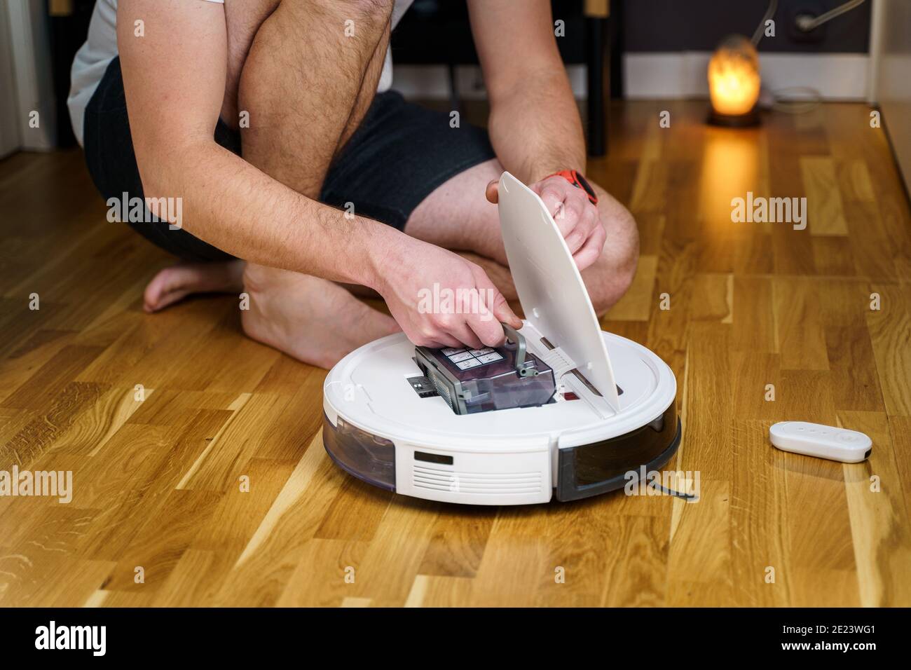 Robot vacuum cleaner repair. Man fixing robot vacuum cleaner DIY at home on  the floor. Robotic vacuum cleaner maintenance and service. Smart device fo  Stock Photo - Alamy