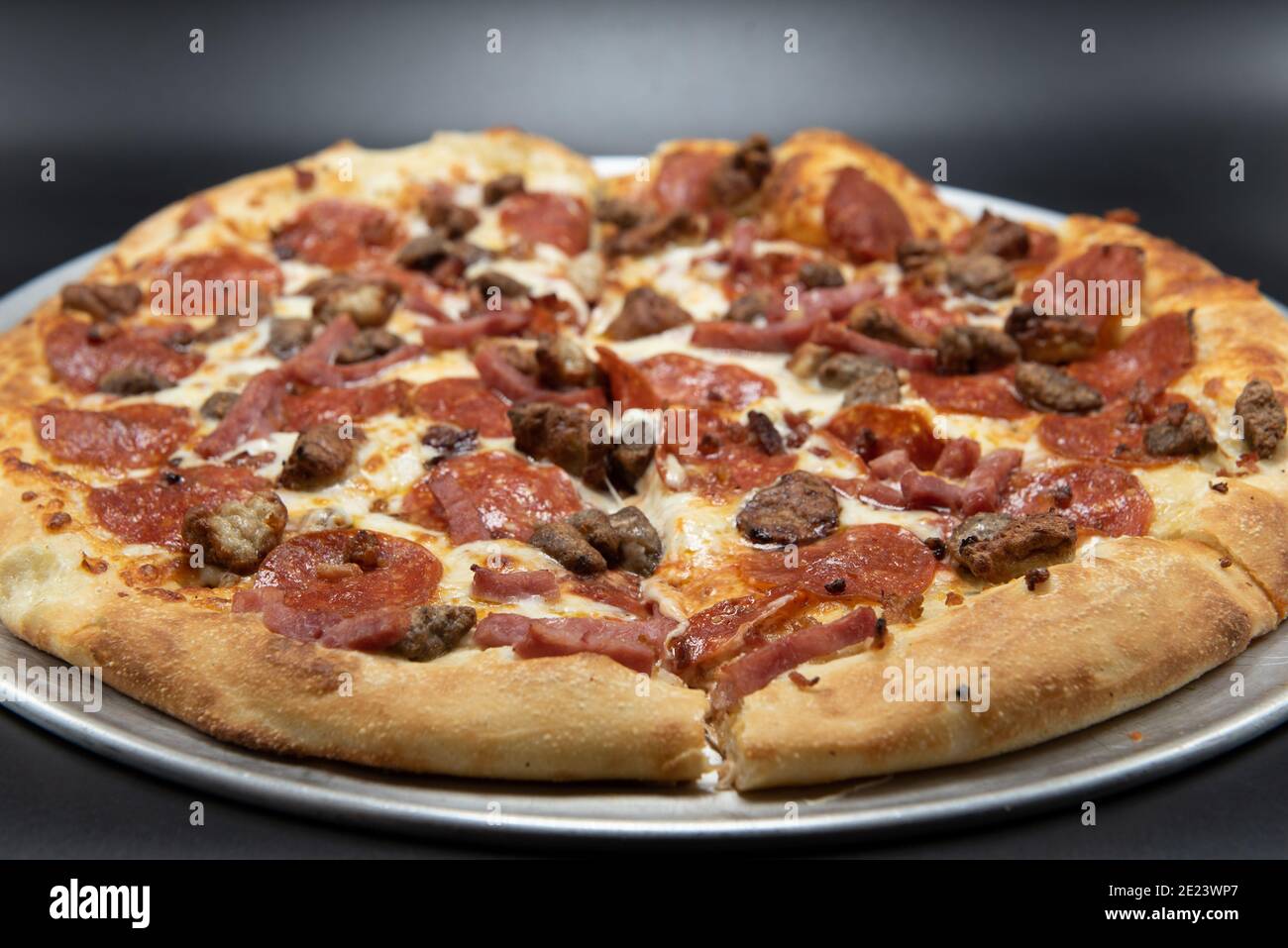 Pepperoni, sausage, bacon, and ham are all the meats that cover this