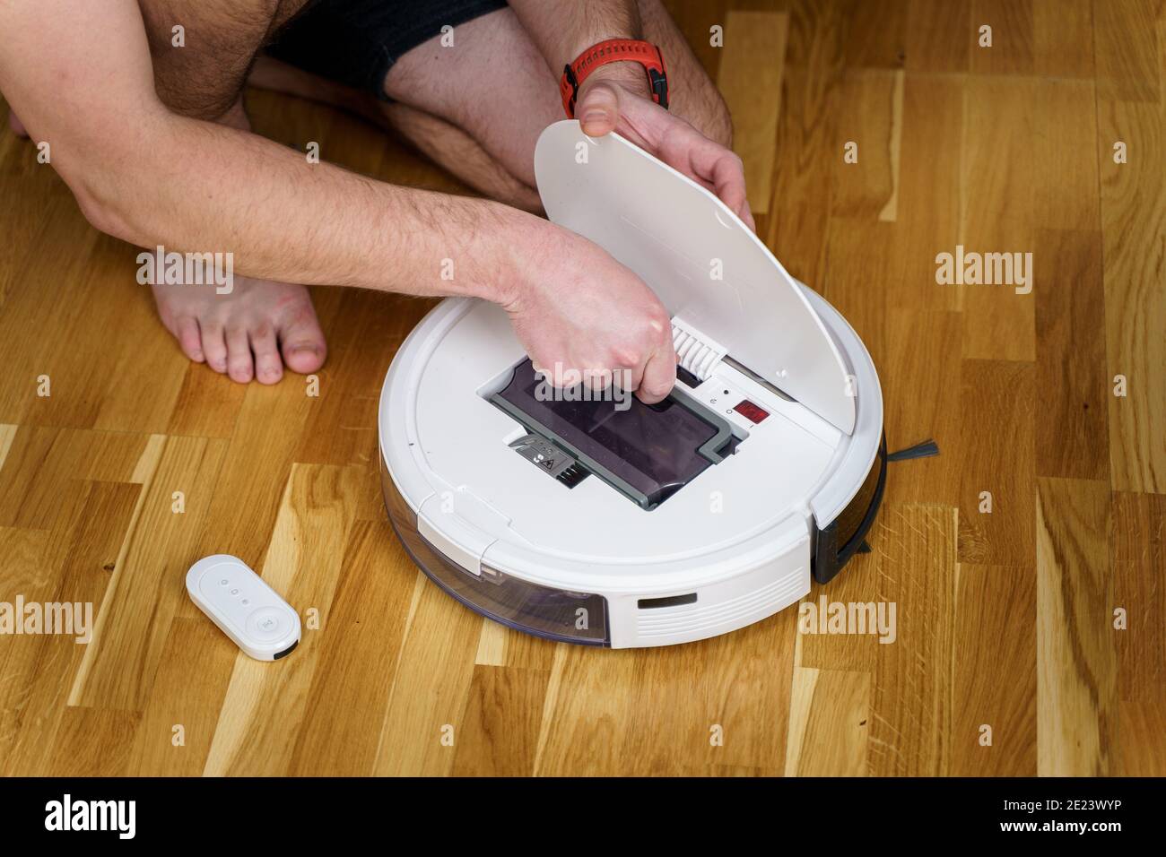 Robot vacuum cleaner repair. Man fixing robot vacuum cleaner DIY at