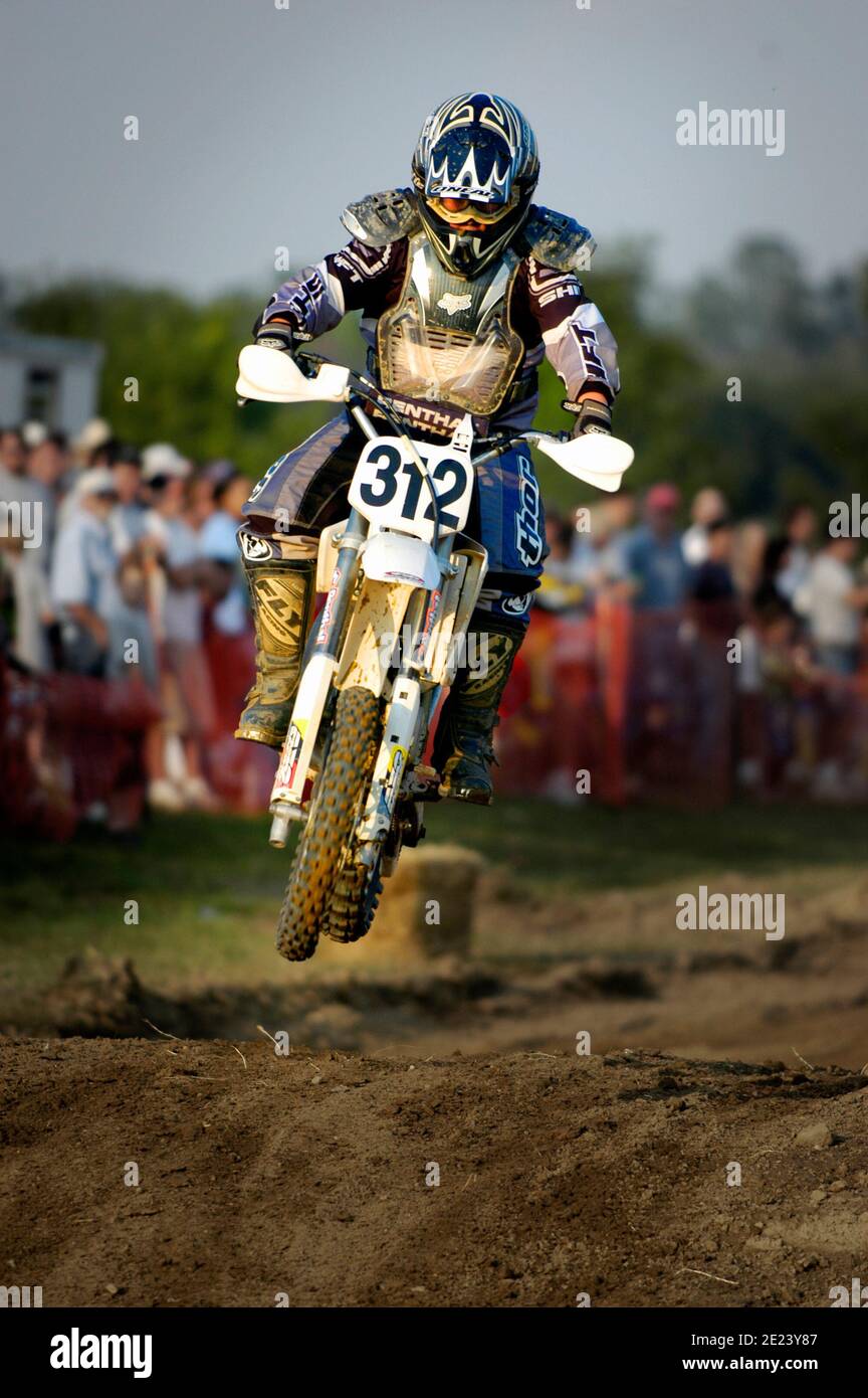 Colorful motorcyclist participate in a motocross motorbike motorcycle race Stock Photo