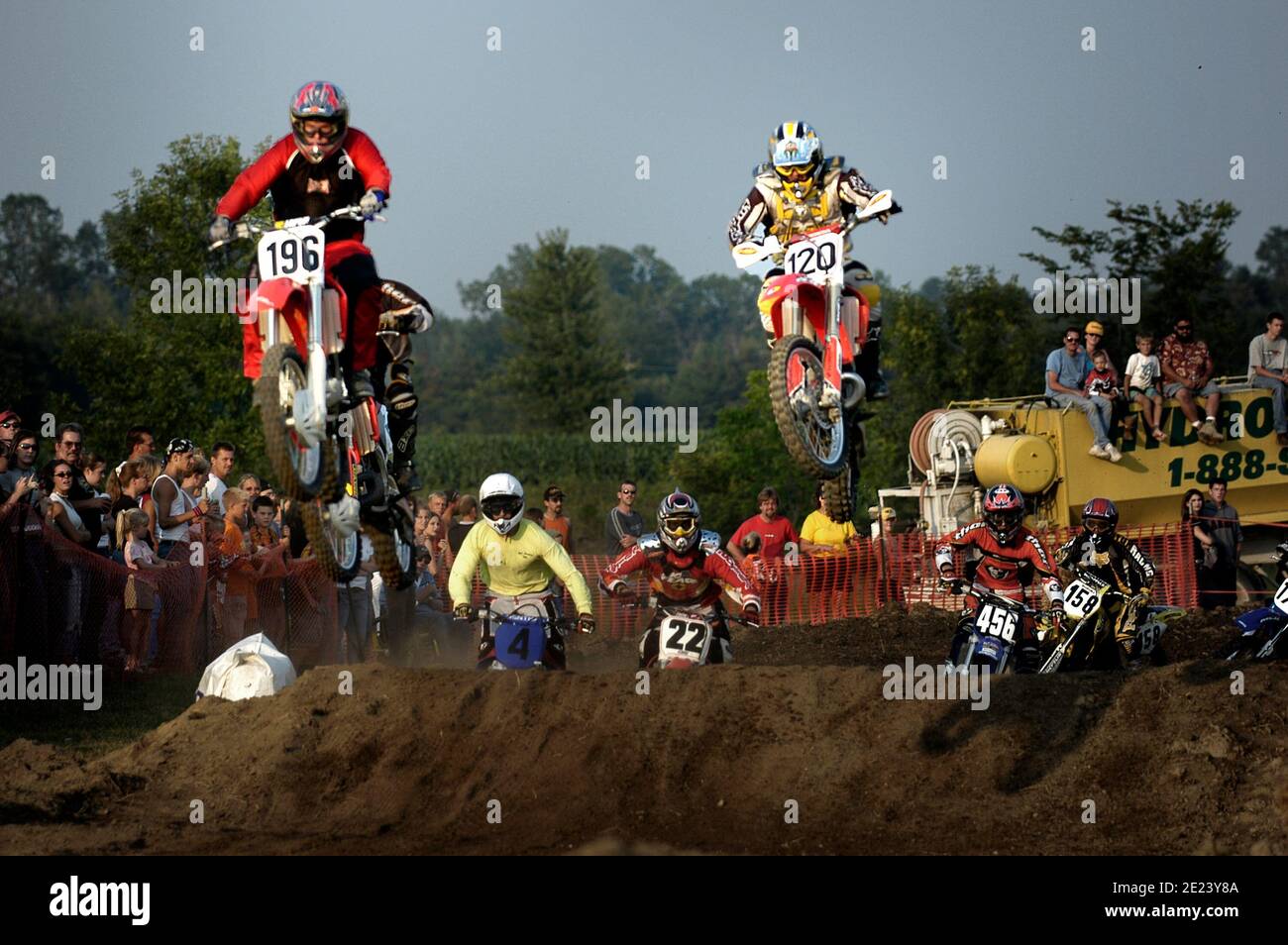 Colorful motorcyclist participate in a motocross bike race Stock Photo