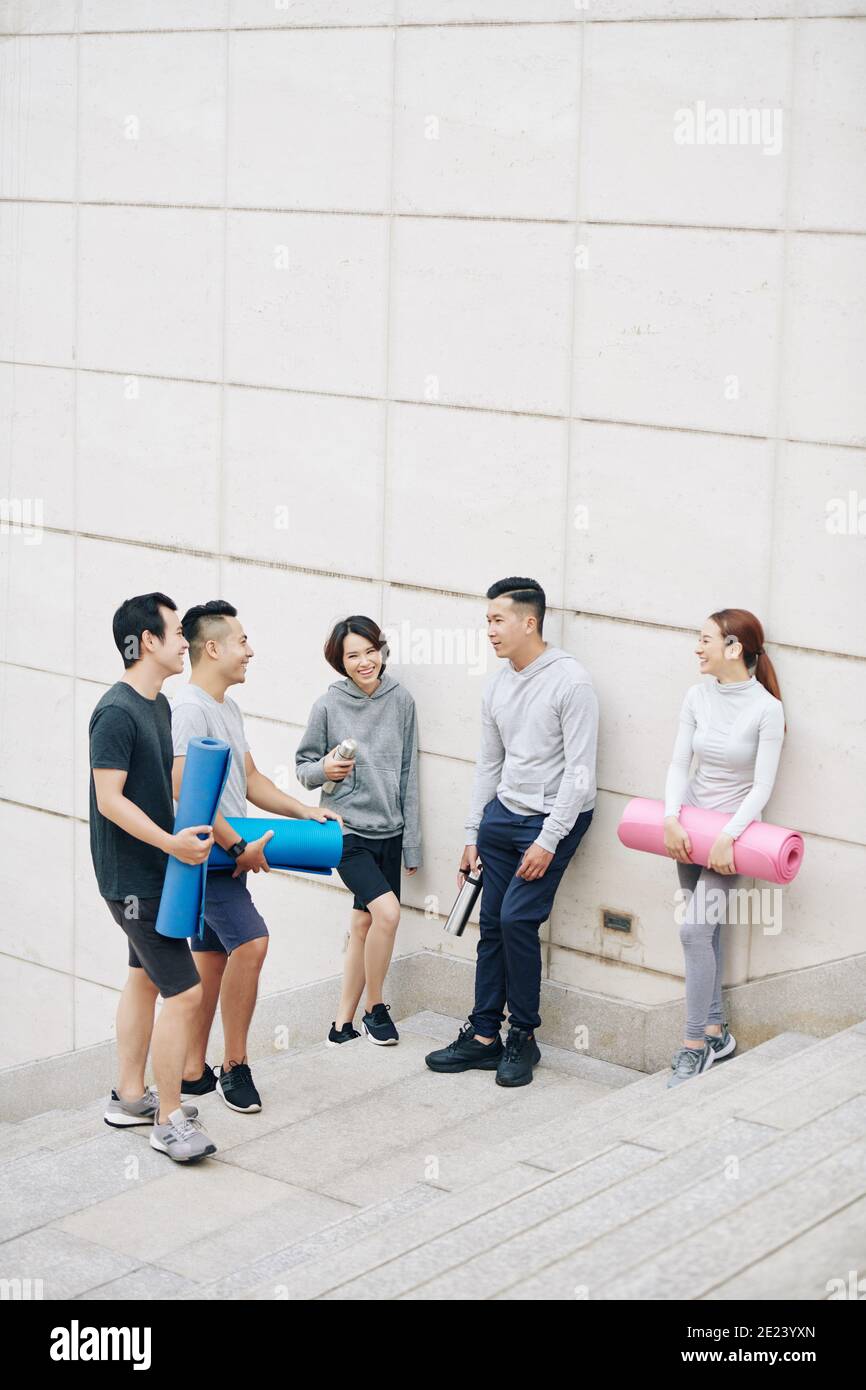 Young people discussing yoga training Stock Photo