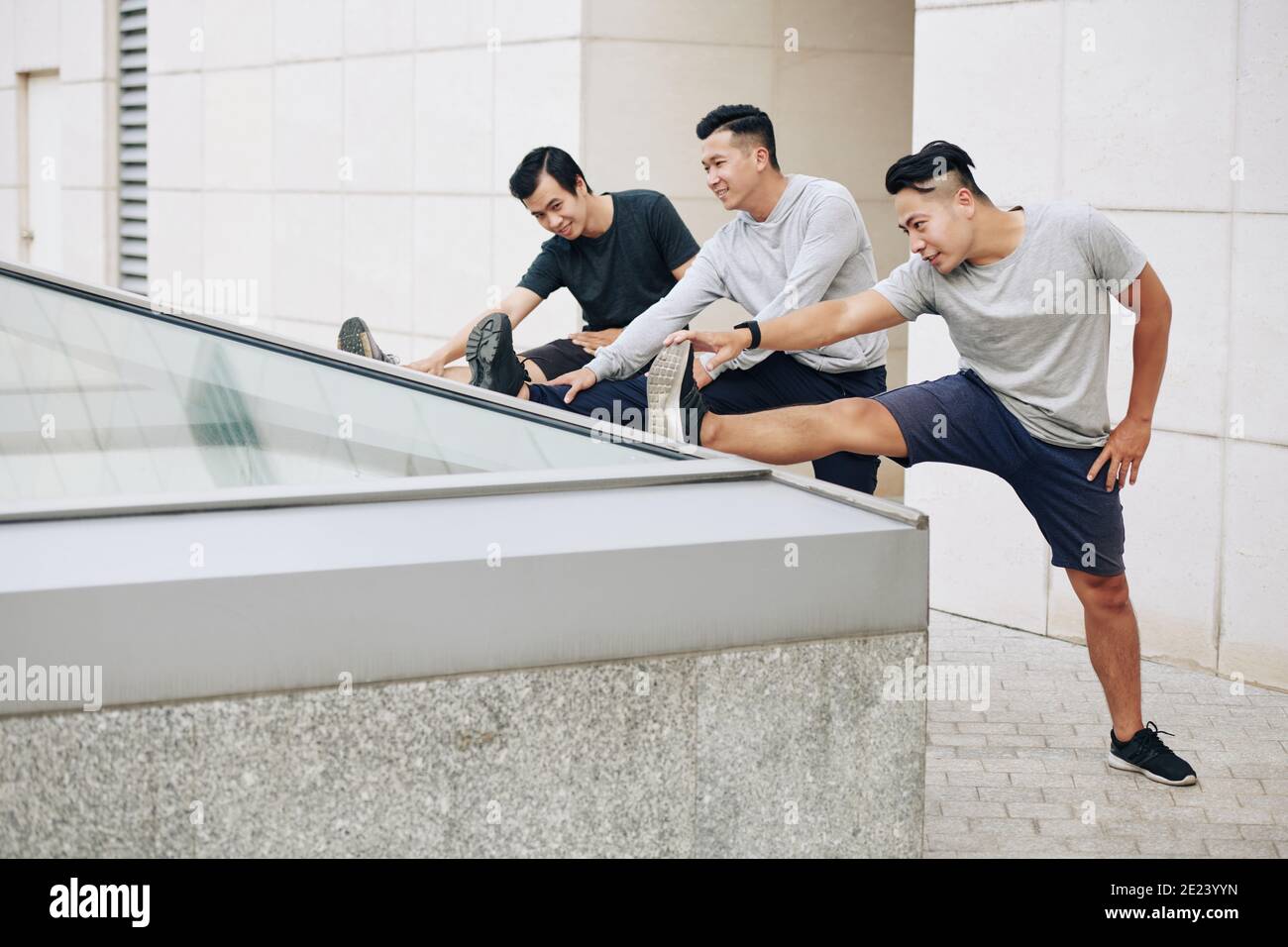 Young Vietnamese men stretching legs Stock Photo Alamy