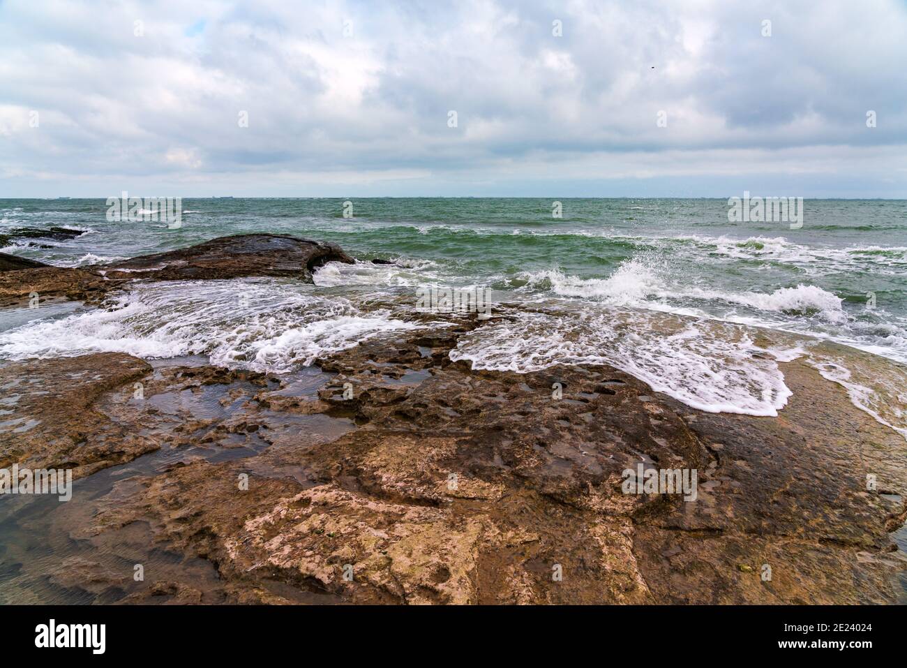 Wave splashing at the rocks, freshness on beach Stock Photo - Alamy