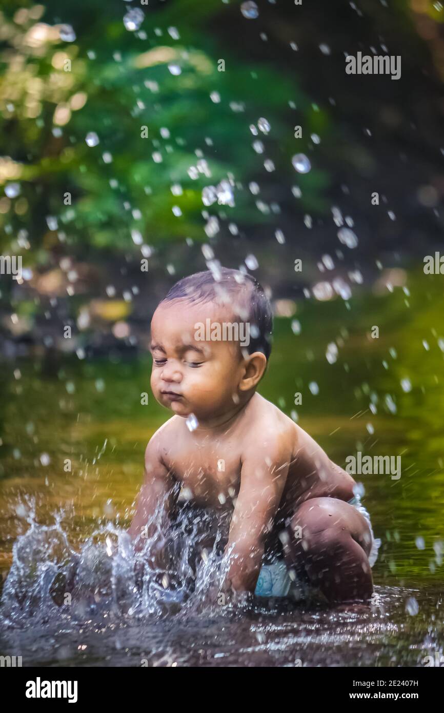 Little Cute Baby Boy Playing In River Water. Portrait of Boy Child ...