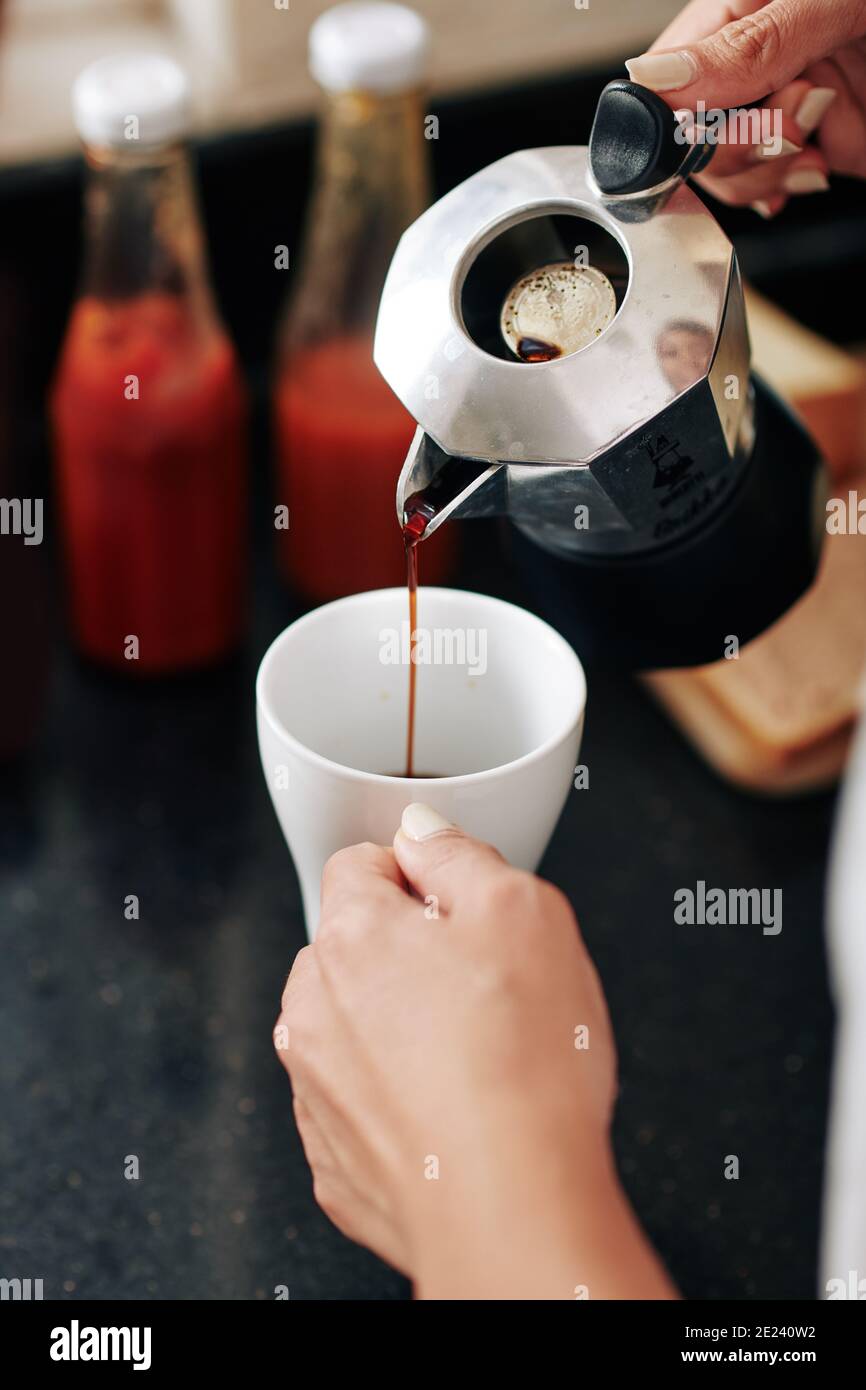 Woman making black coffee Stock Photo