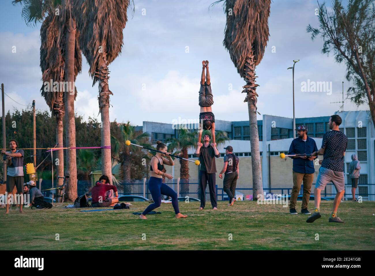 People Practice Acro Yoga, slackline, Spirits, Juggling, Outdoors in the park. Healthy Lifestyle, Tel Aviv, Israel. High quality photo Stock Photo