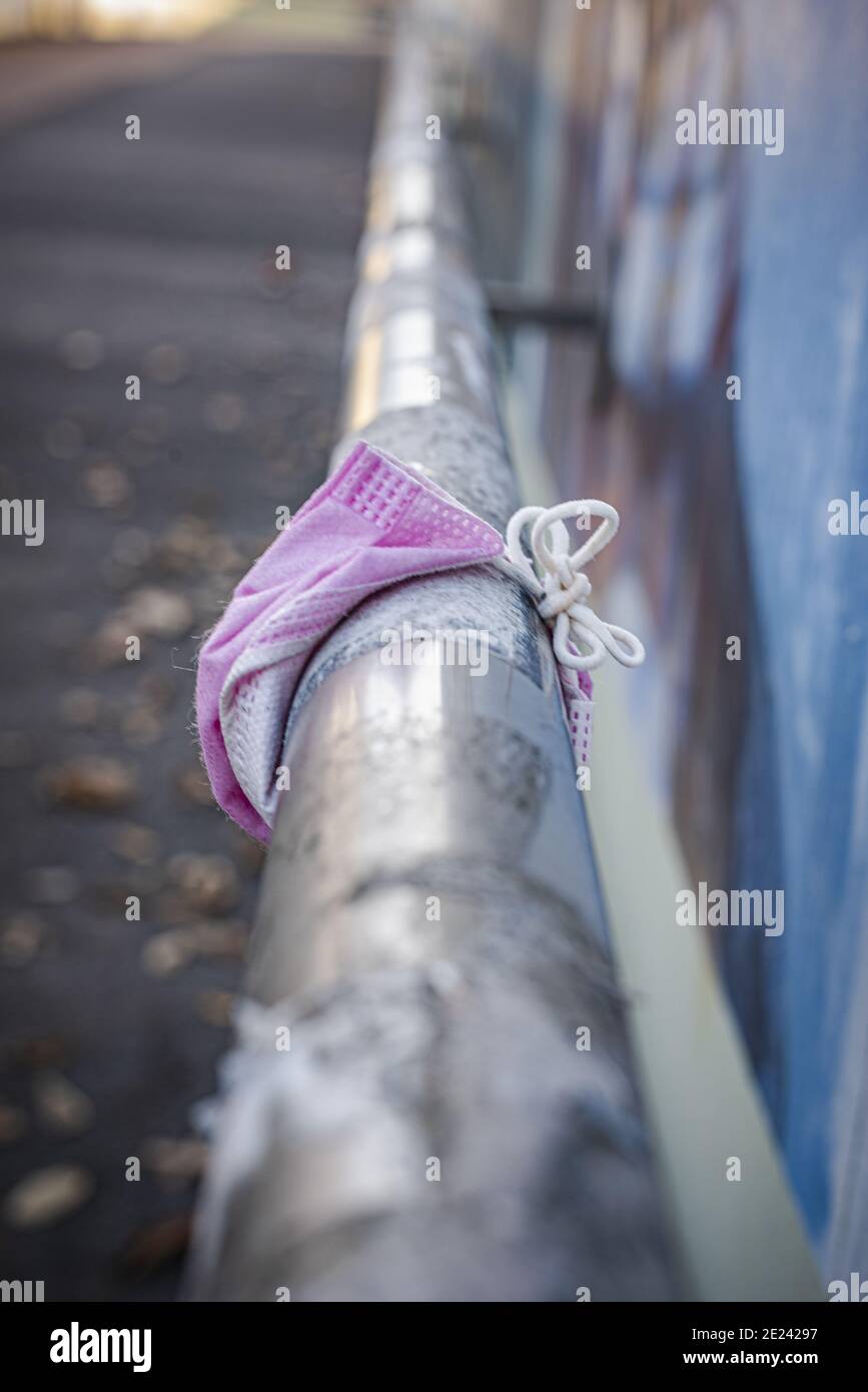 Pink protective mask on a handrail Stock Photo