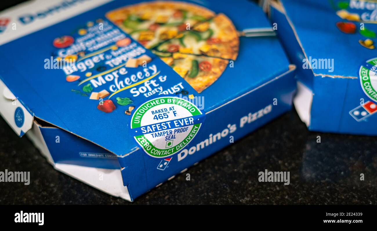 Domino's pizza box sealed with tamper proof seal for zero contact delivery. Stock Photo