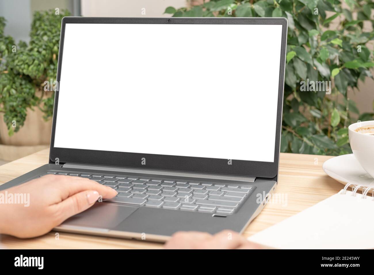 Mockup image of a woman using and touching on laptop computer touchpad