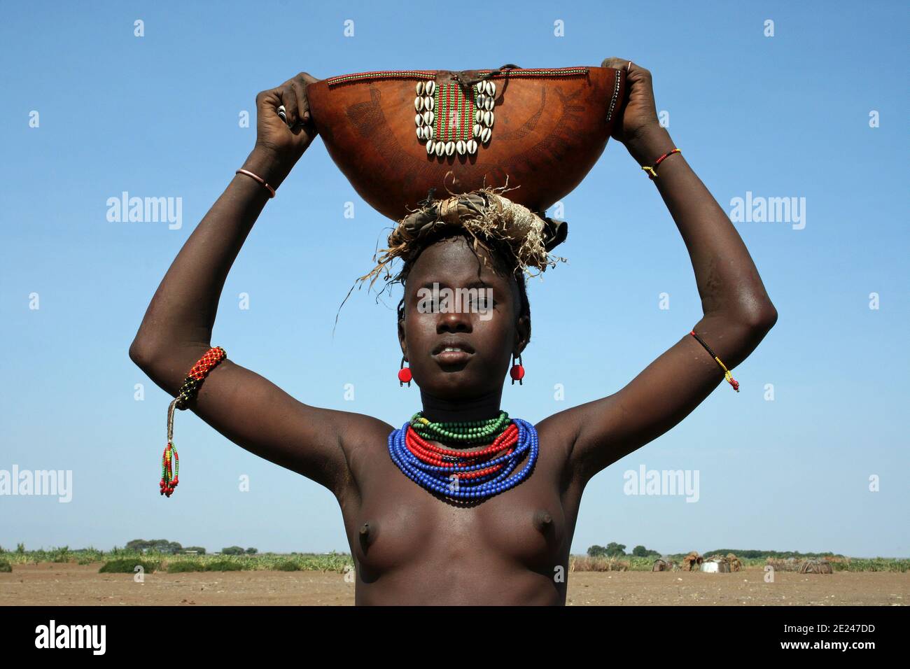 Young Dassanech Tribe Woman Holding Traditional Gourd, Omorate, Omo Valley, Ethiopia Stock Photo