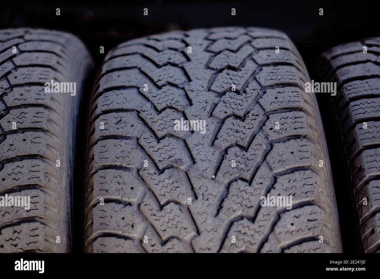 Old car tires stand on a metal rack in the installation workshop Stock  Photo - Alamy