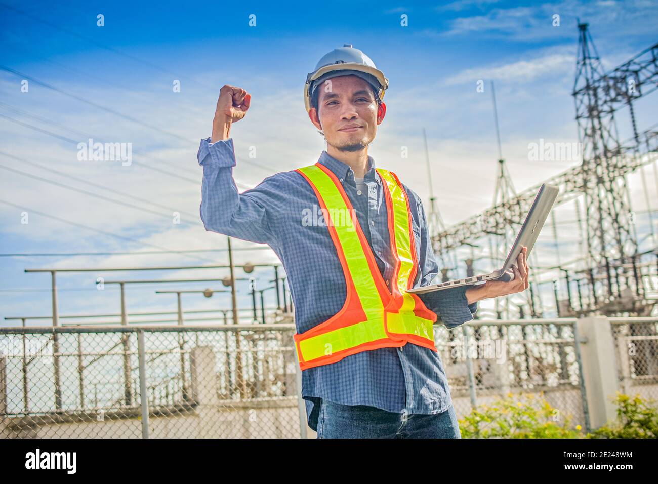 Electrical engineer hold computer notebook at high volte station Stock Photo
