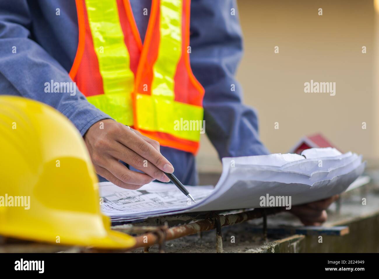 Engineer inspection on site building construction with blueprint Stock