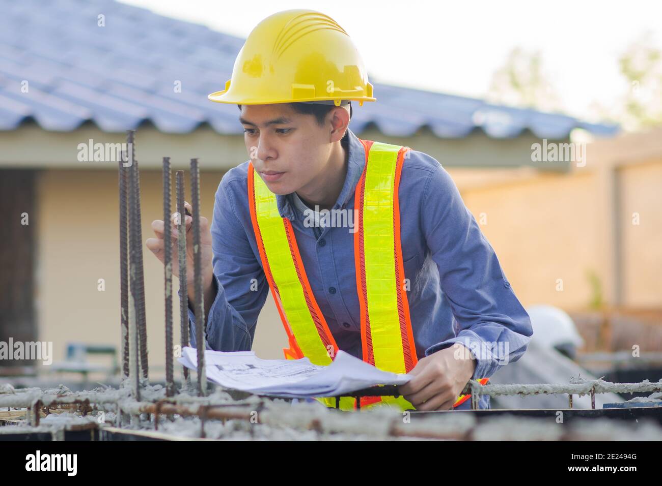 Engineer inspection on site building construction with blueprint Stock