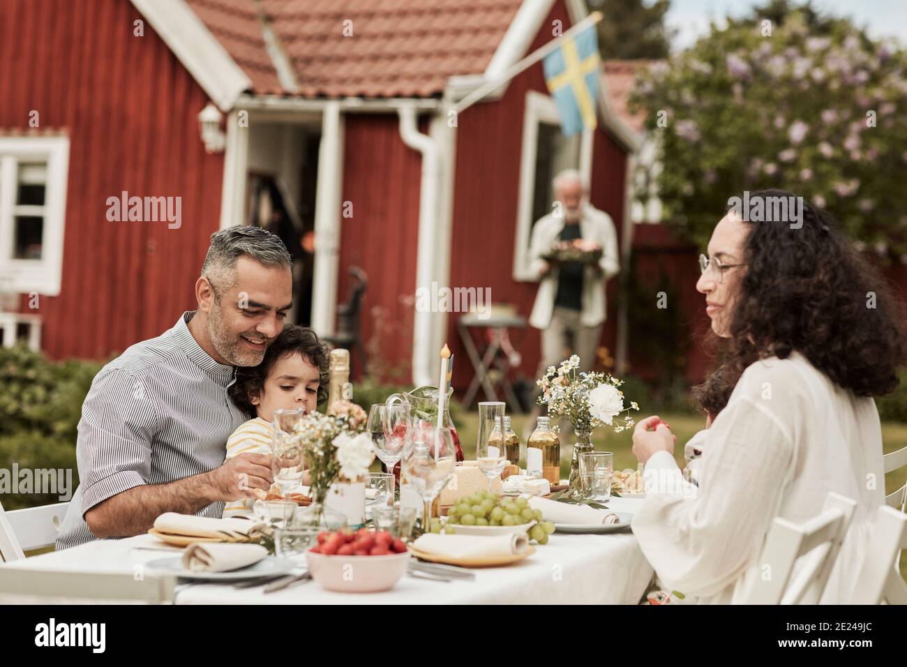 Family having meal in garden Stock Photo