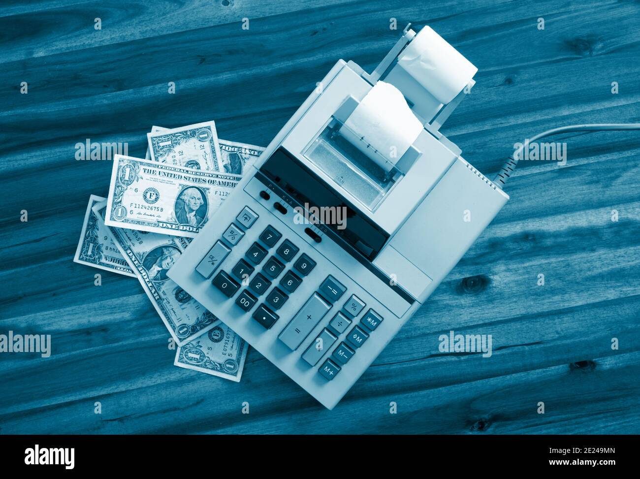 Old fashioned calculator and dollars on a desk Stock Photo