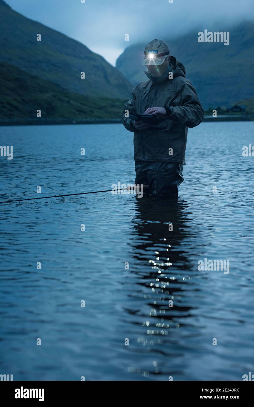 Man fishing in lake Stock Photo