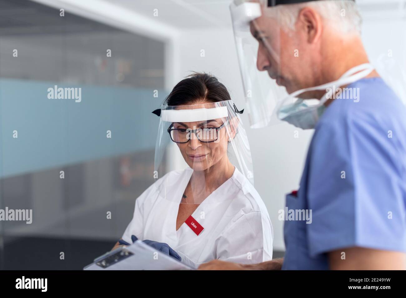 Doctors wearing personal protective equipment in hospital Stock Photo